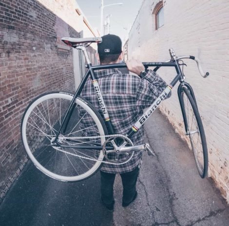 man-carrying-white-and-black-bianchi-road-bike-990427.jpg